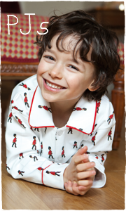 Child happy in pyjamas on the floor